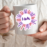 AFFIRMATION, Mantra, Meditation, Motivational, I AM Sun Vinyl Sticker. Has 36 positive words like rays of the sun. The middle says, I AM. Colors are pink, purple, red on a coffee mug