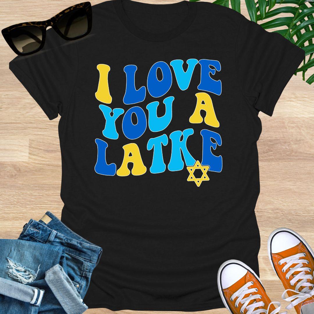 Retro blue and gold “I Love You a Latke” text with a small Star of David on a black unisex Hanukkah tee.