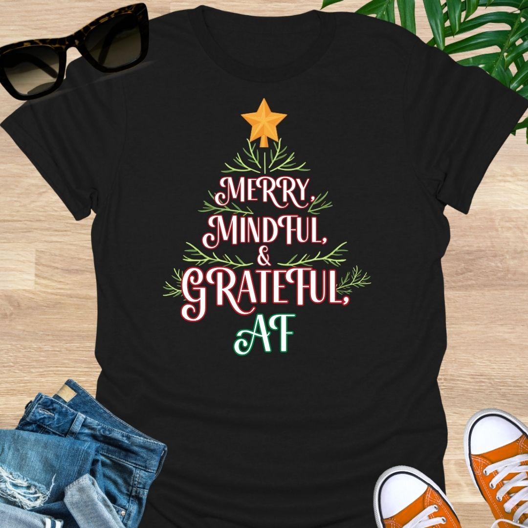 “Merry, Mindful & Grateful, AF” Christmas text forming a tree with greenery and star on a black unisex tee.