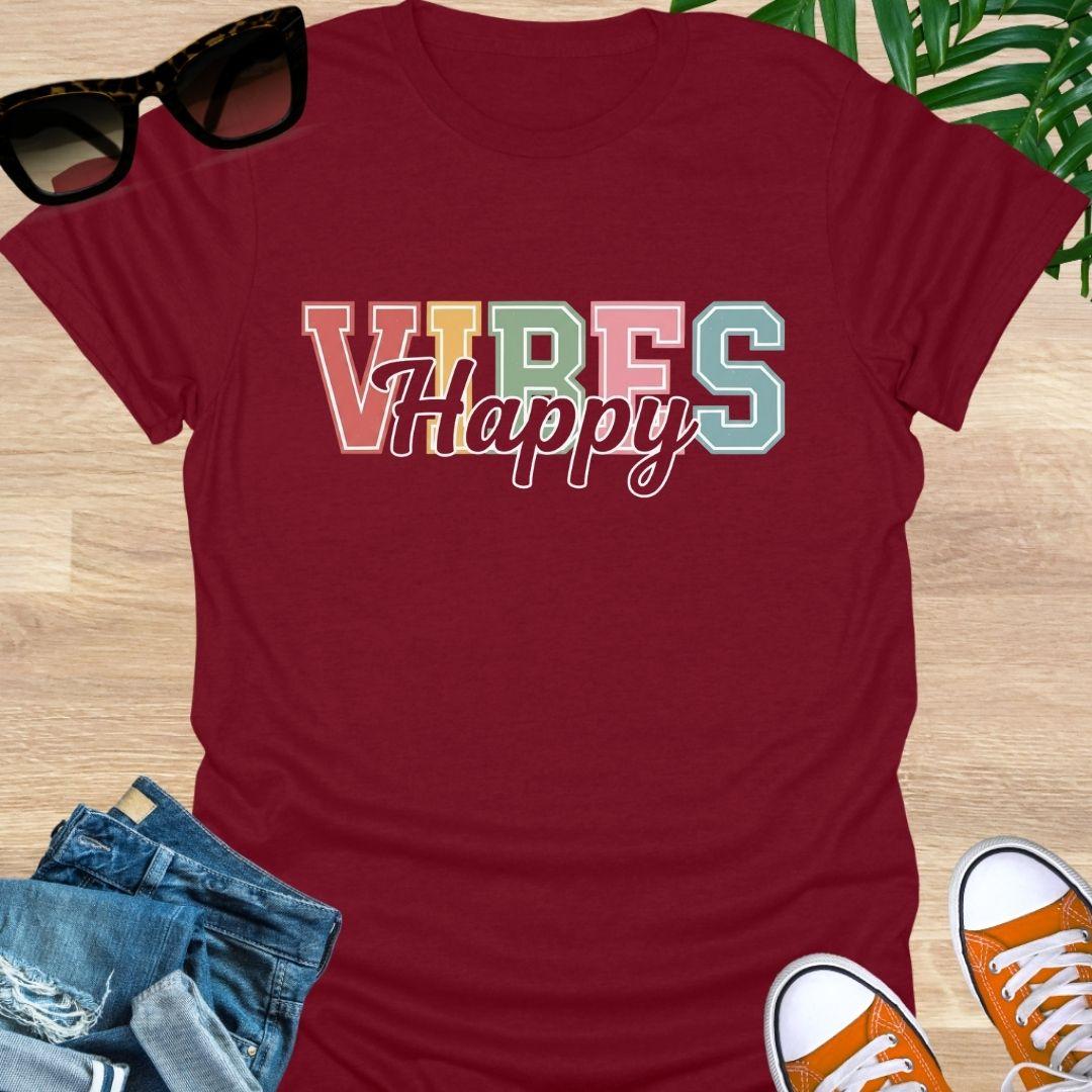 “Happy Vibes” in retro varsity letters with script overlay on a red unisex tee.