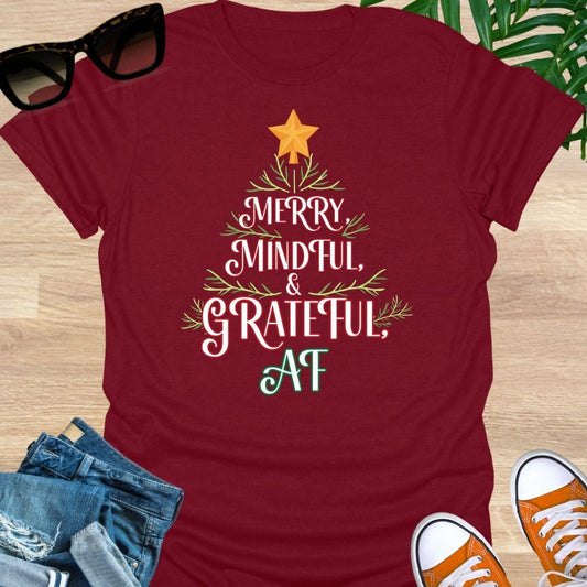 “Merry, Mindful & Grateful, AF” Christmas text forming a tree with greenery and star on a red unisex tee.