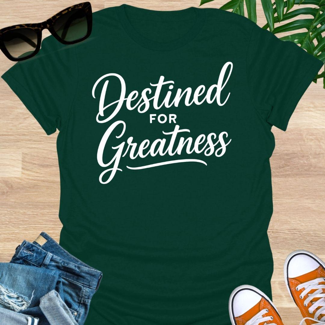 White script text reading “Destined for Greatness” on a forest green motivational graphic tee.