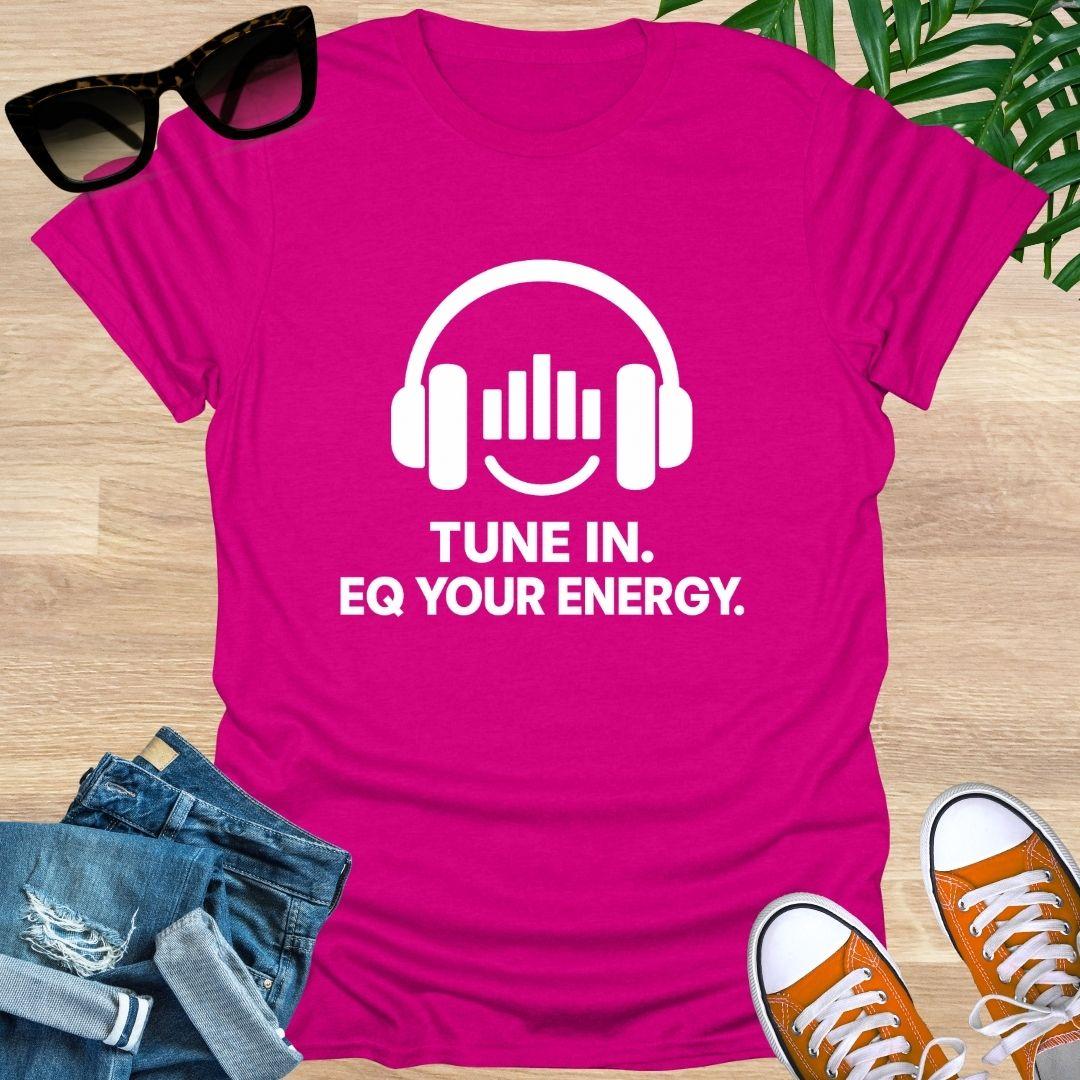 Pink t-shirt with headphones graphic and text 'Tune In. EQ Your Energy.
