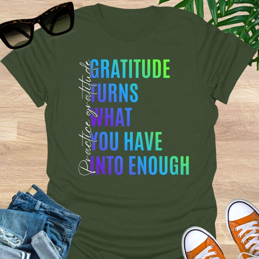 Gradient text tee reading “Gratitude turns what you have into enough” with script “practice gratitude" on a military green unisex tee