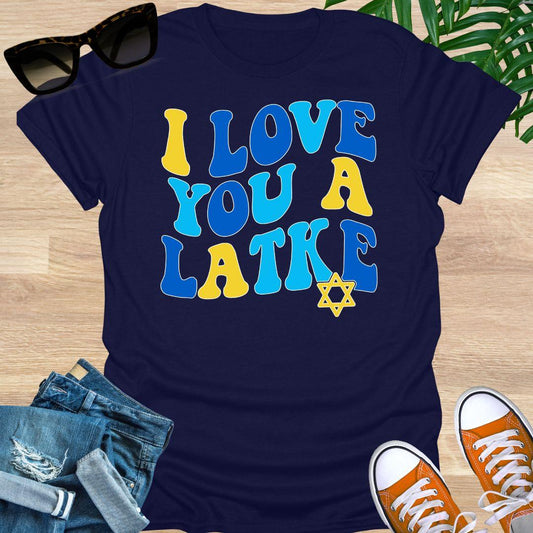 Retro blue and gold “I Love You a Latke” text with a small Star of David on a navy blue unisex Hanukkah tee.