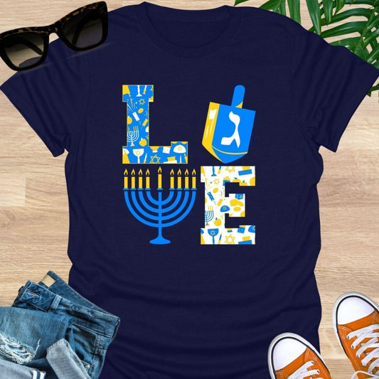 LOVE Hanukkah design with dreidel “O”, menorah “V”, and blue-gold holiday icons on a navy unisex tee.