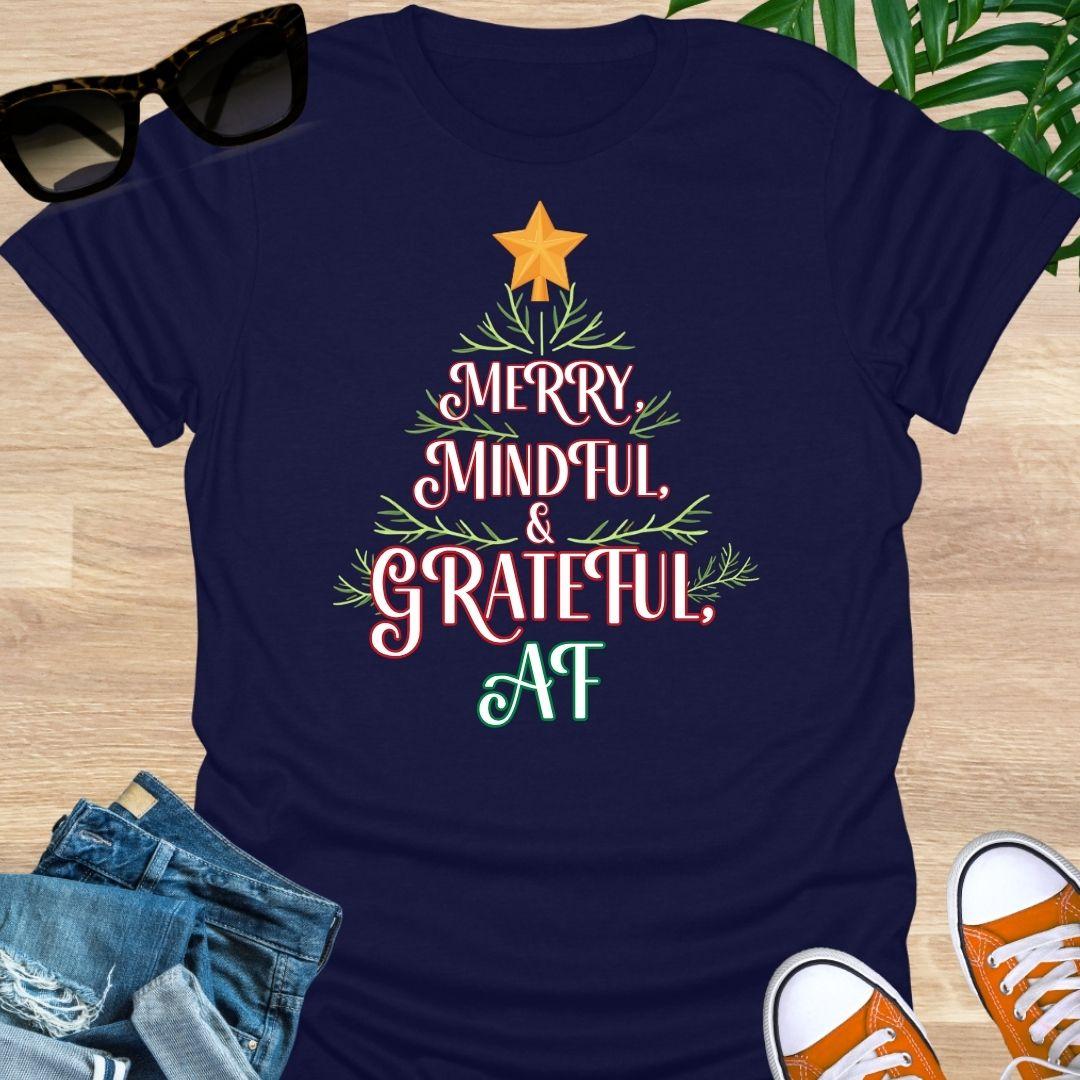“Merry, Mindful & Grateful, AF” Christmas text forming a tree with greenery and star on a navy unisex tee.