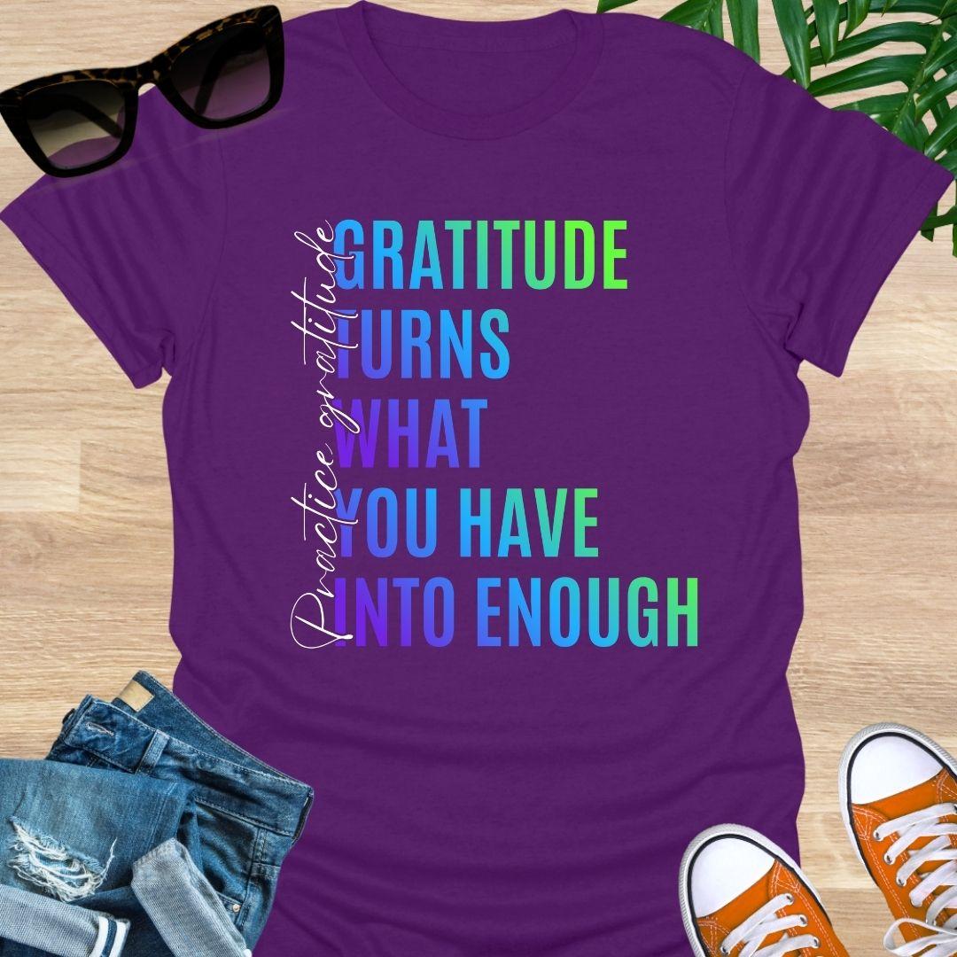 Gradient text tee reading “Gratitude turns what you have into enough” with script “practice gratitude" on a purple unisex tee