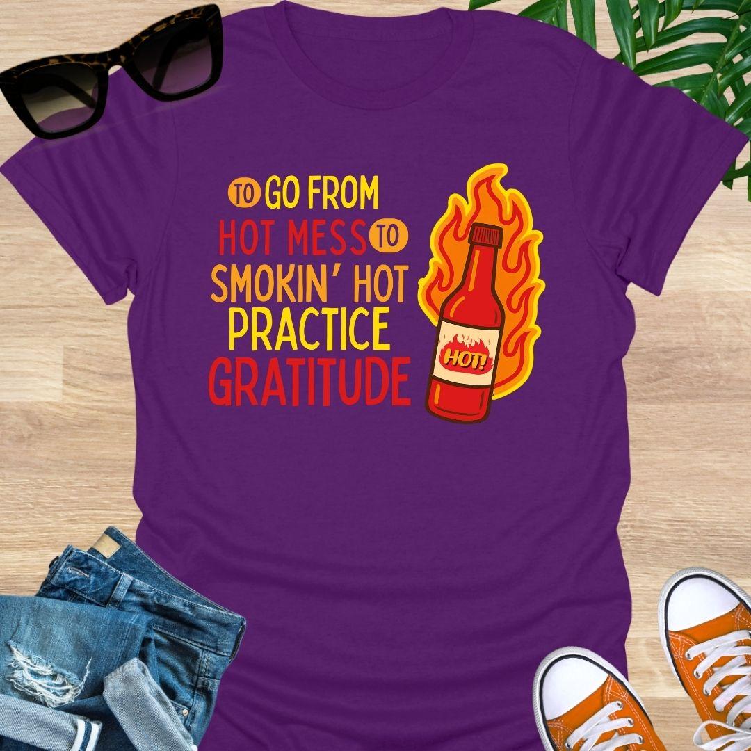 Flaming hot sauce bottle beside the text “Hot Mess to Smokin’ Hot, Practice Gratitude” on a purple unisex tee.