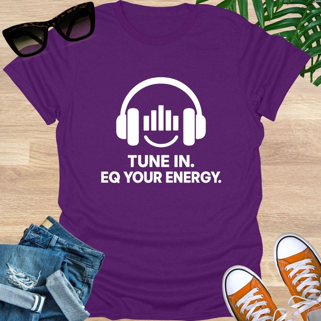 Purple t-shirt with headphones graphic and text 'Tune In. EQ Your Energy.