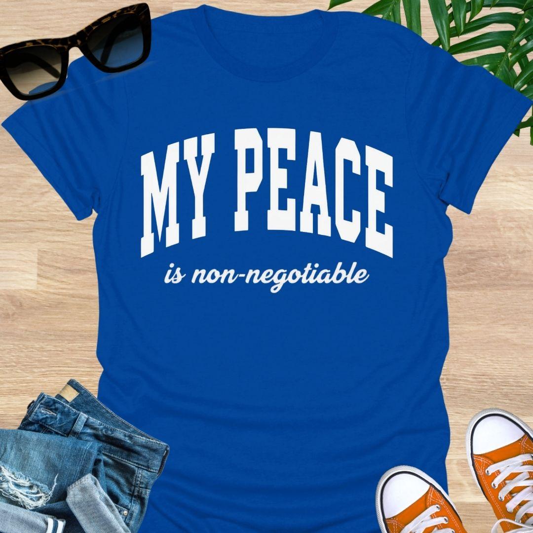 “My Peace Is Non-Negotiable” in white collegiate lettering on a blue unisex tee.