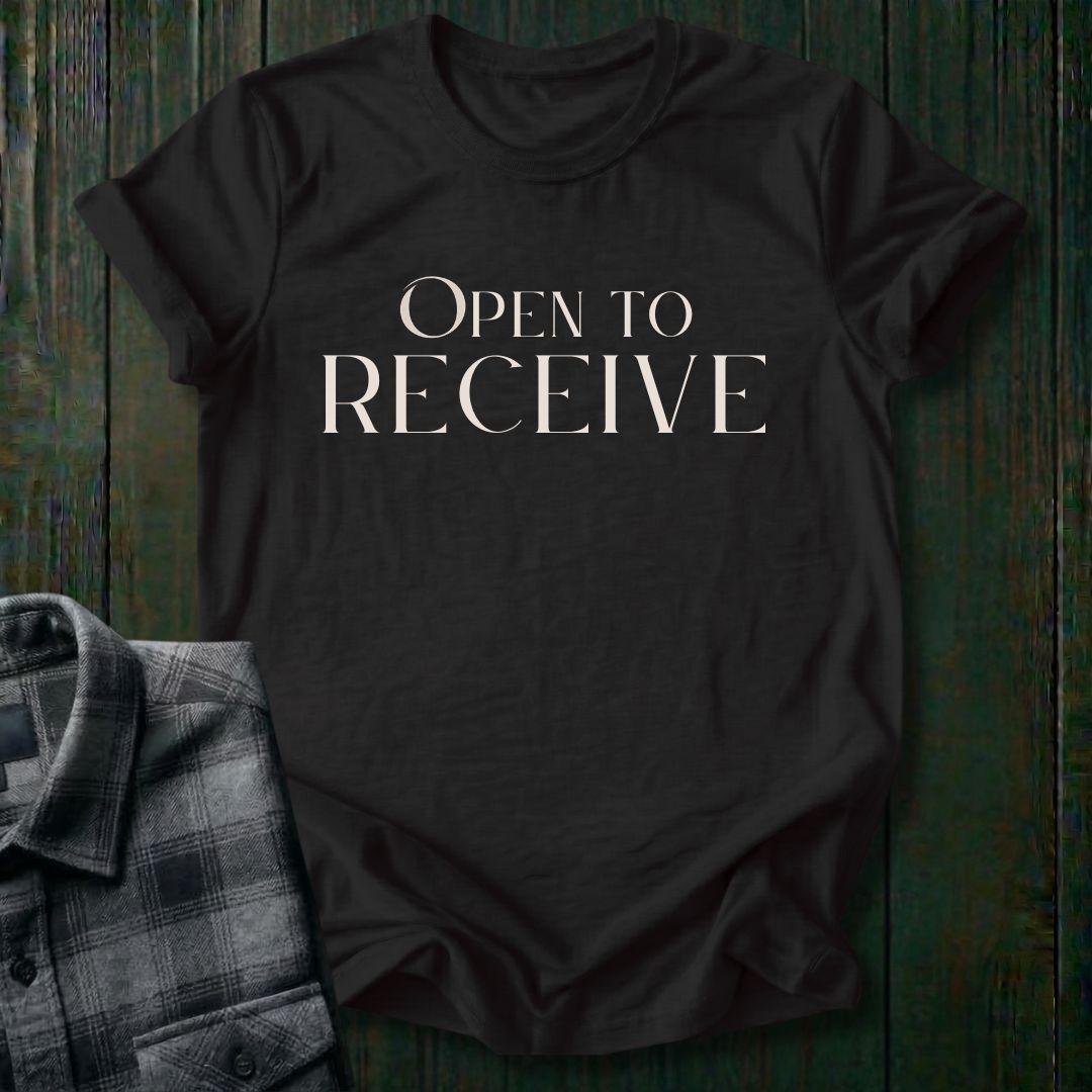 Elegant minimalist typography design featuring the phrase "Open to Receive" in refined serif lettering on a  black tee