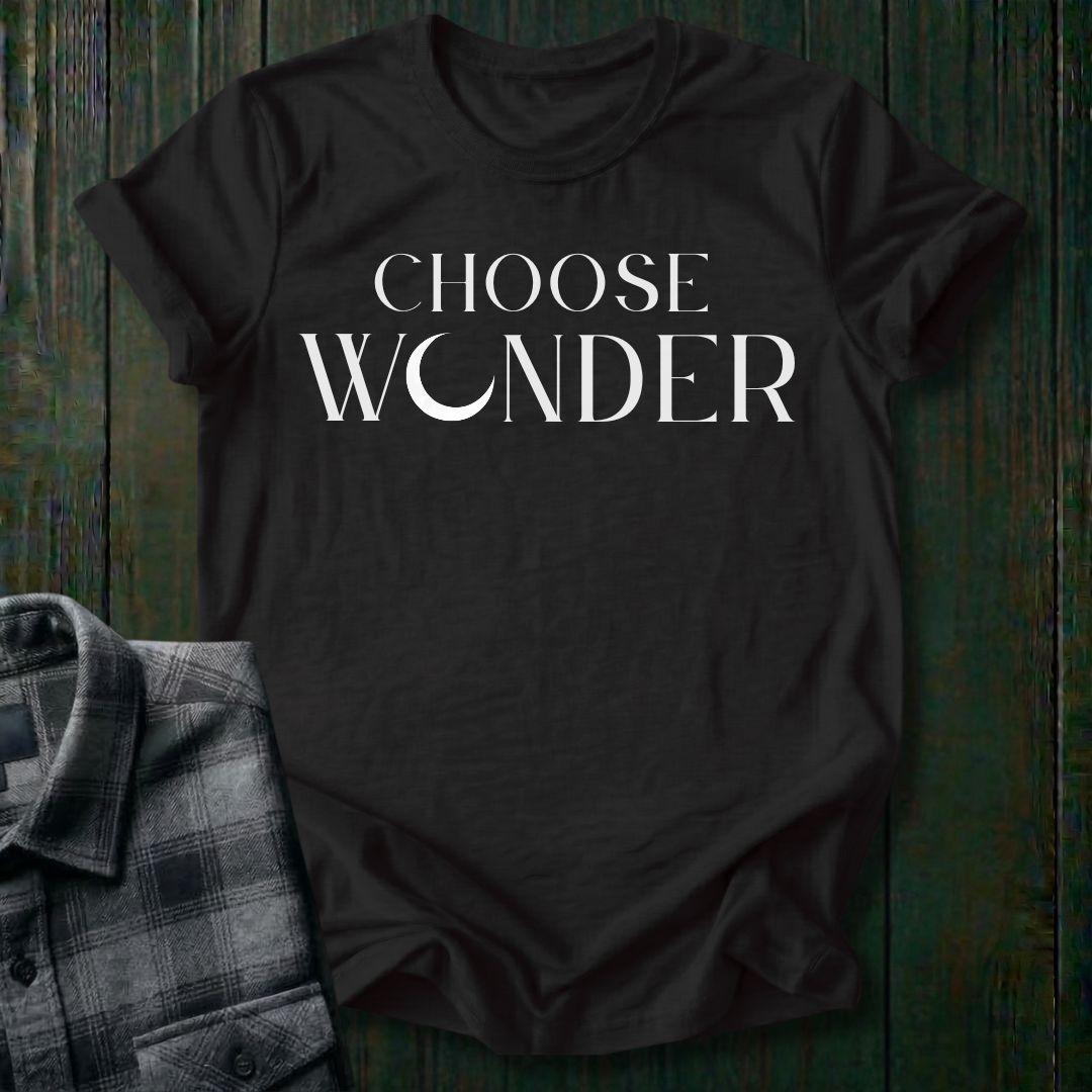 Minimalist typography design featuring the phrase "Choose Wonder" in elegant serif lettering on a black tee