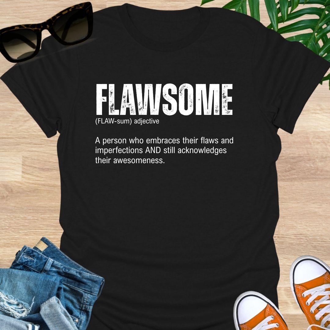 Blackunisex t-shirt with  “FLAWSOME” definition in bold white type—embrace flaws and awesomeness