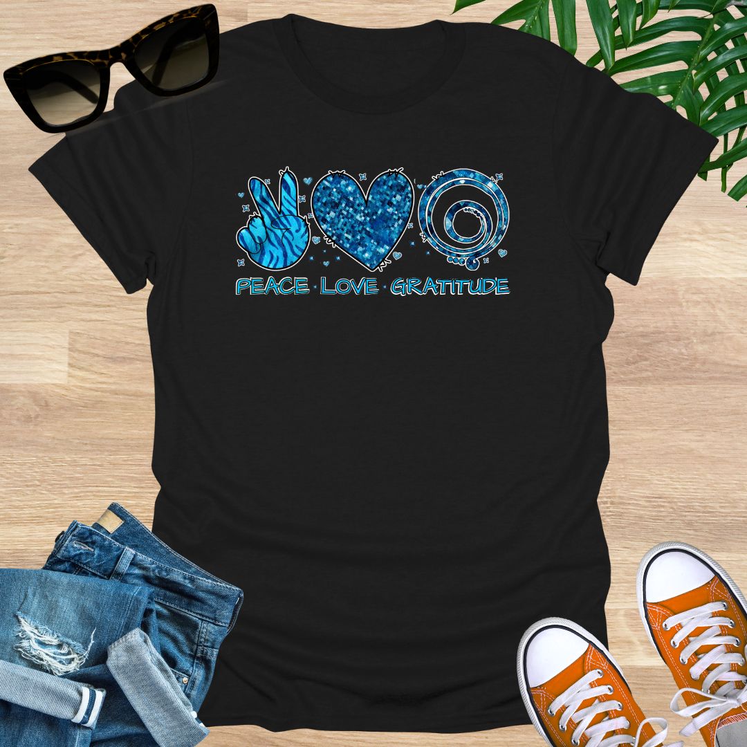 Black unisex T-shirt with peace sign, heart, and spiral text reading “Peace • Love • Gratitude.”
