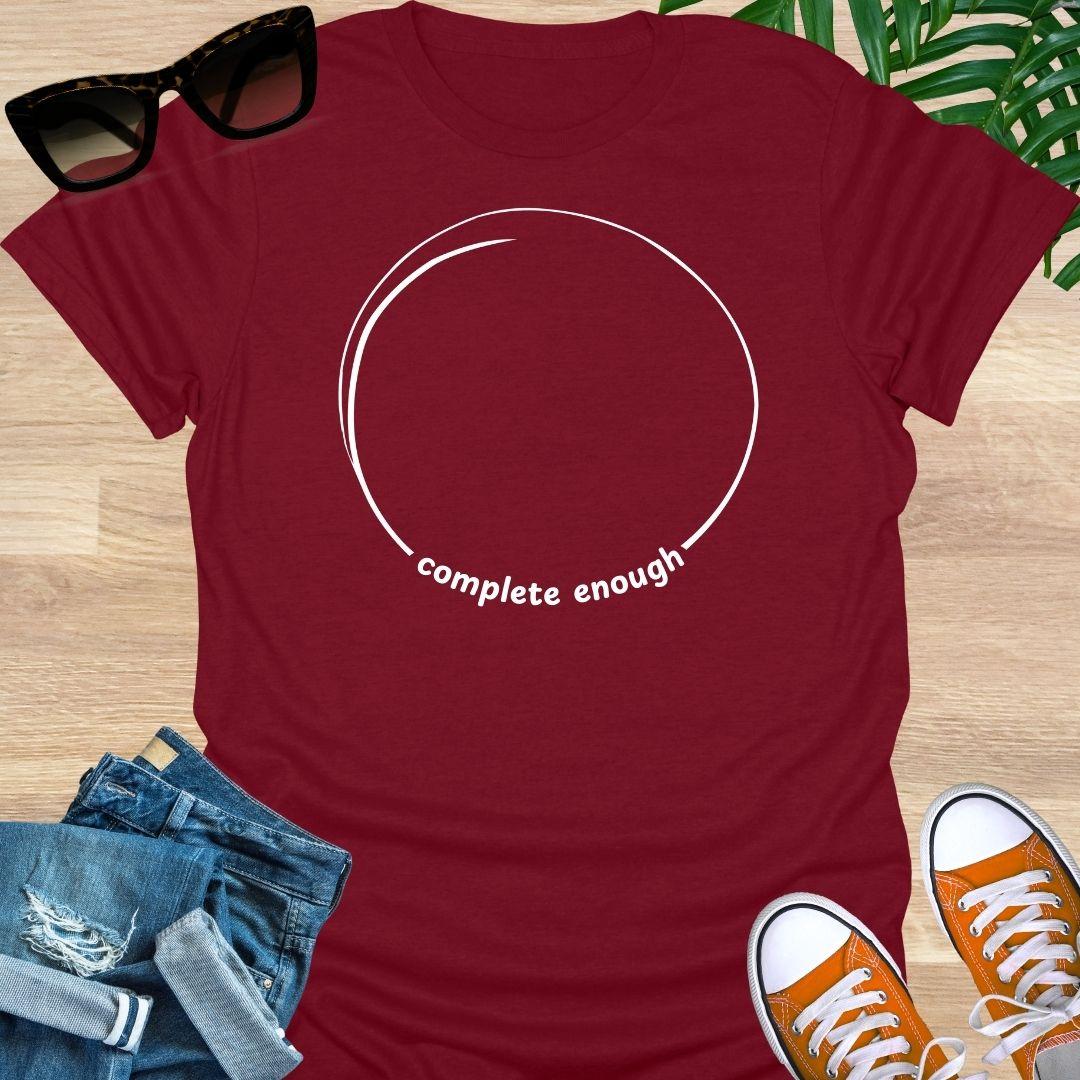Minimal incomplete circle line art with the words “complete enough” on a red unisex t-shirt