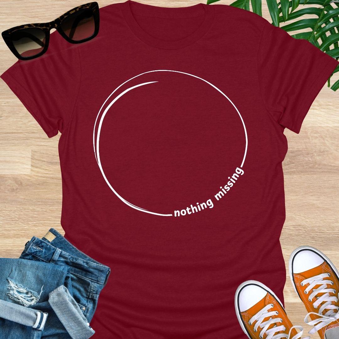 Minimal incomplete circle line art with the words “nothing missing” on a red unisex t-shirt