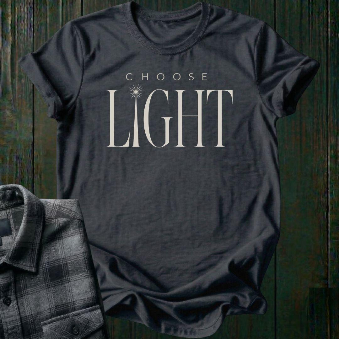 Elegant minimalist typography design featuring the phrase "Choose Light" with a radiant sunbeam replacing the letter I in "Light" on a charcoal tee