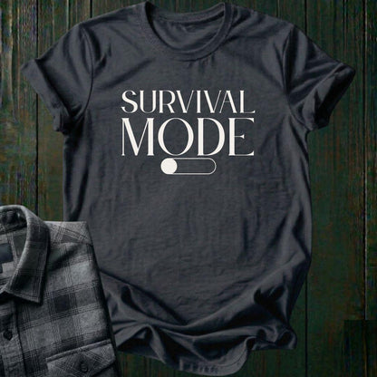 Minimalist typography design featuring the phrase "Survival Mode Off" with a toggle switch graphic in the off position on a charcoal gray tee. 