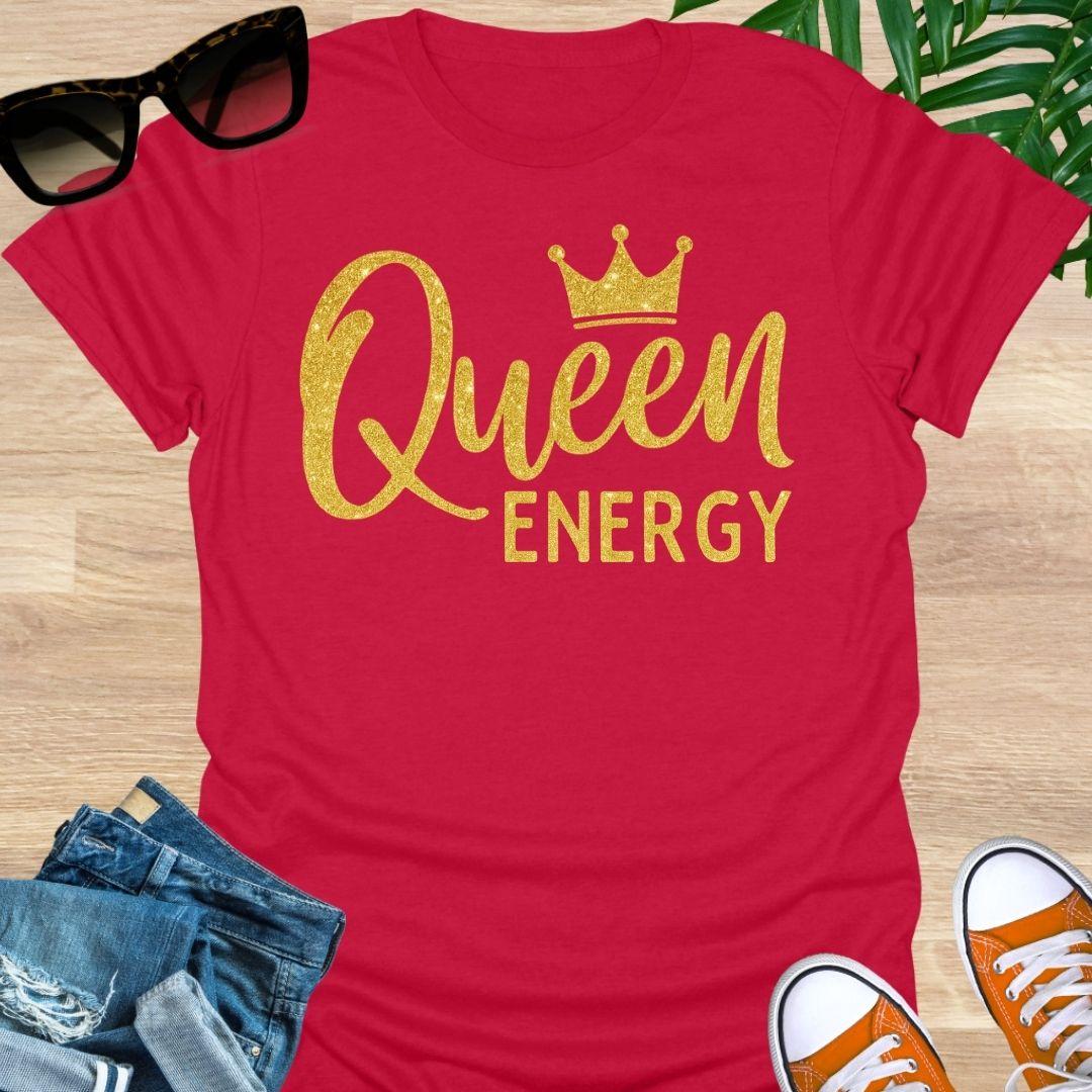 Gold glitter script “Queen Energy” with a crown on a red empowerment graphic tee.