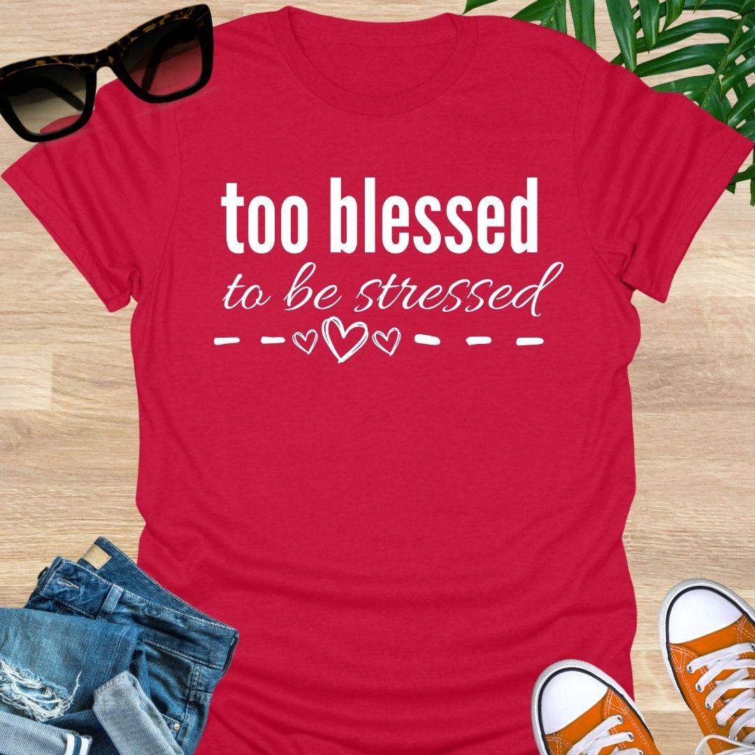“Too Blessed to Be Stressed” text tee with hand-drawn hearts, white lettering on a red unisex T-shirt.
