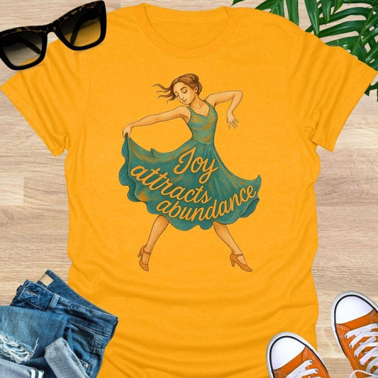Joy attracts abundance dancer illustration on a yellow unisex manifesting tee