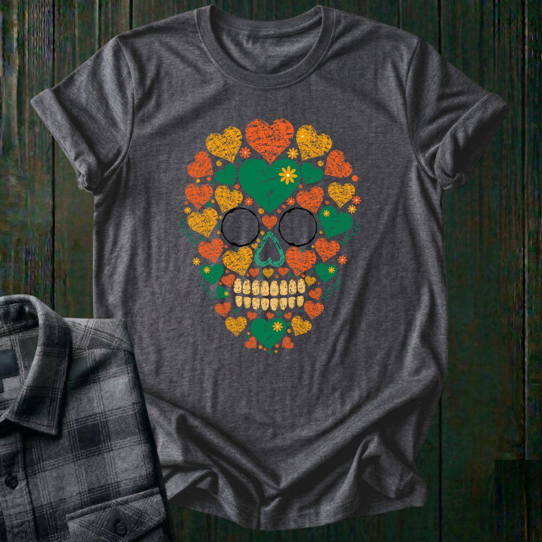 Distressed floral skull graphic made from colorful hearts, flowers, and botanical elements in green, orange, and yellow vintage-style artwork on a heather charcoal tee