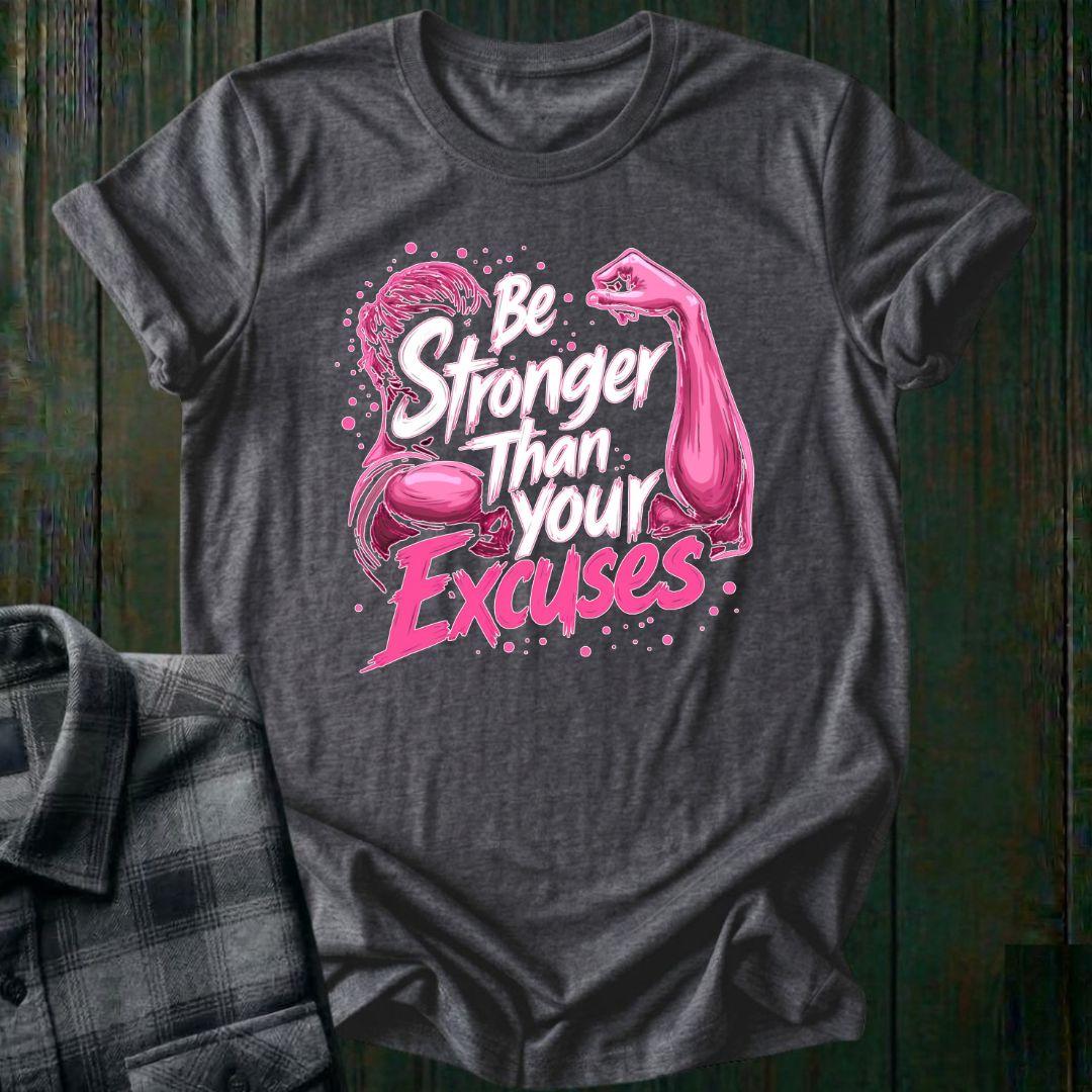 Gray t-shirt with pink graphic and text 'Be Stronger Than Your Excuses' on a wooden background