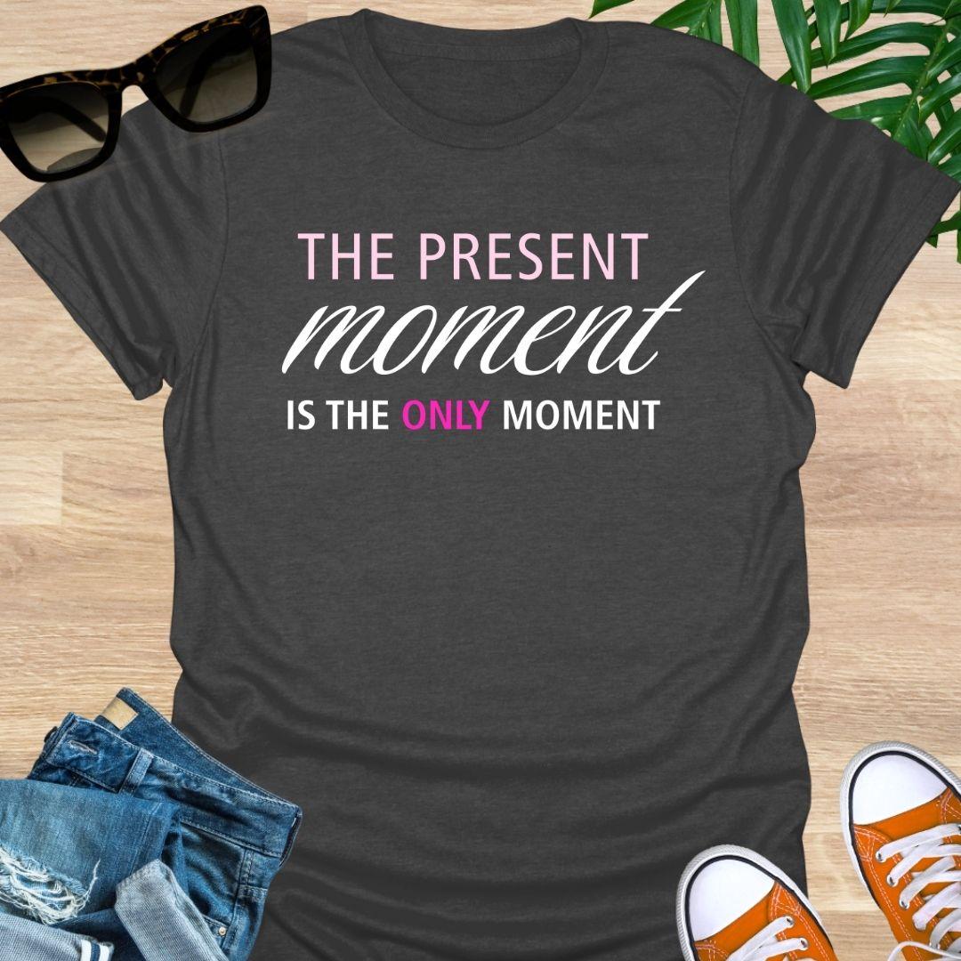 Heather Gray tee with pink/white text reading “The Present Moment Is the Only Moment” minimalist mindfulness graphic.