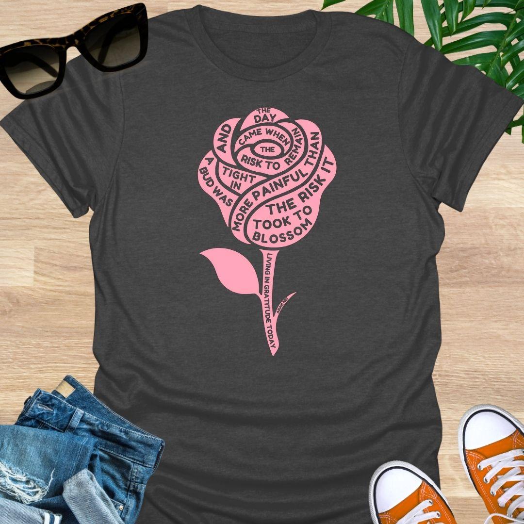 Pink rose with Anaïs Nin “Risk to Blossom” quote on empowerment and growth on heather gray unisex tee