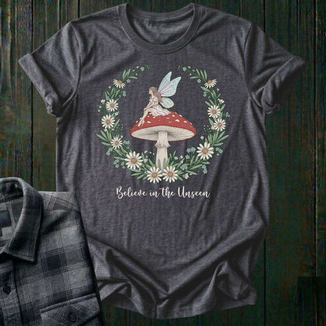 Heathered Gray t-shirt with fairy and mushroom design on a wooden surface
