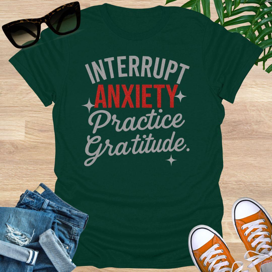 “Interrupt Anxiety, Practice Gratitude” sparkle text on a forest green unisex mindfulness tee