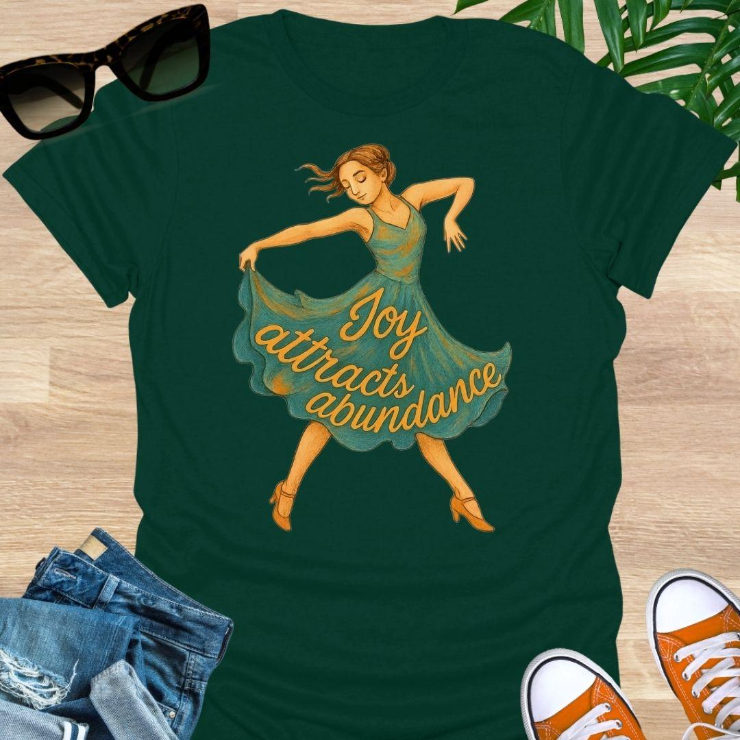 Joy attracts abundance dancer illustration on a forest green unisex manifesting tee