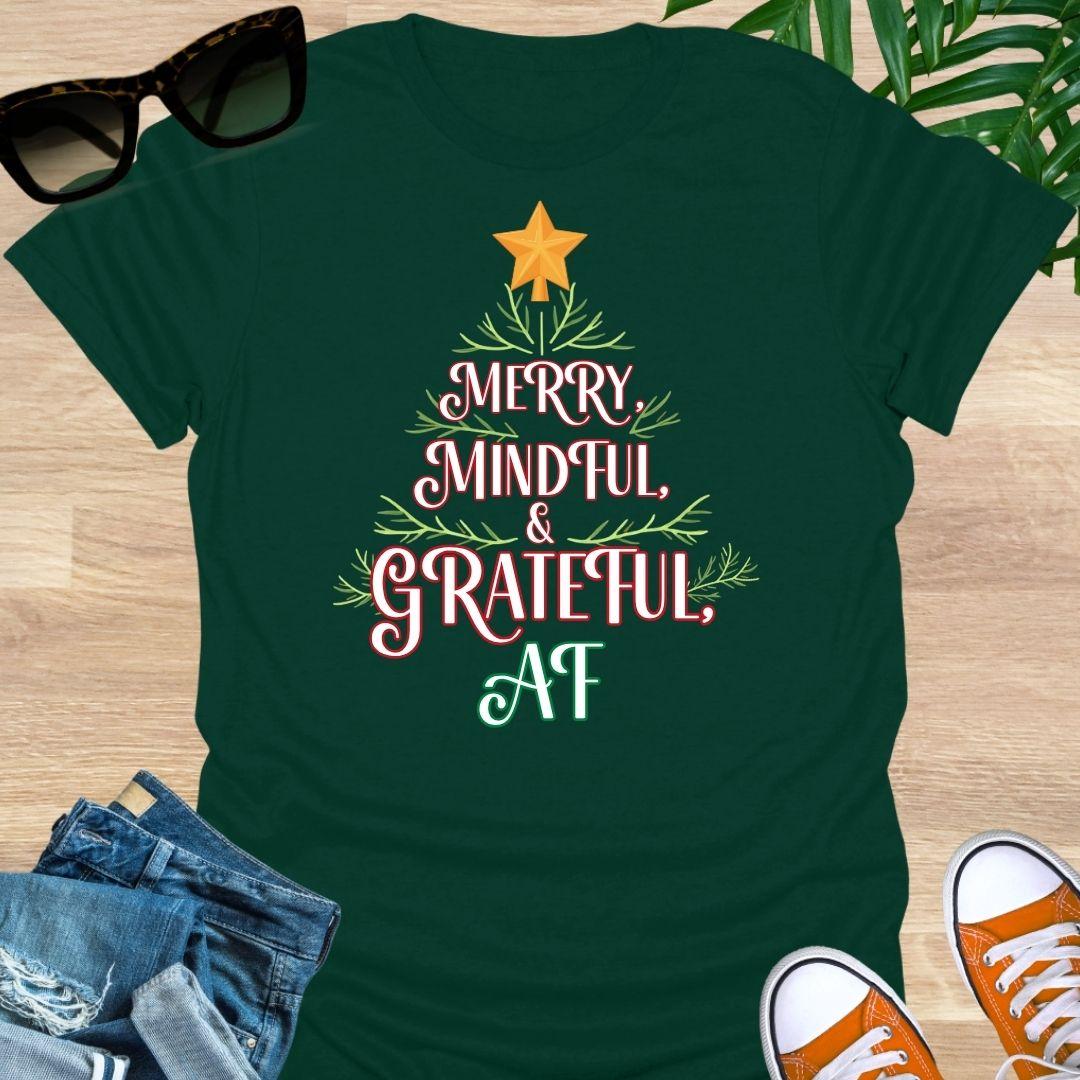 “Merry, Mindful & Grateful, AF” Christmas text forming a tree with greenery and star on a forest green unisex tee.