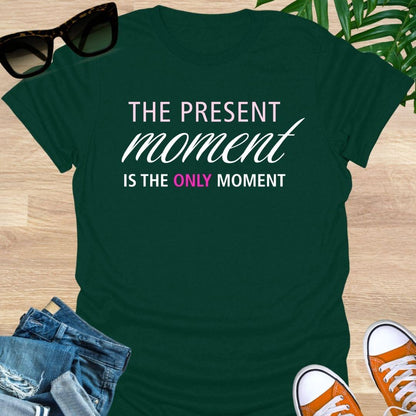 Forest Green tee with pink/white text reading “The Present Moment Is the Only Moment” minimalist mindfulness graphic.