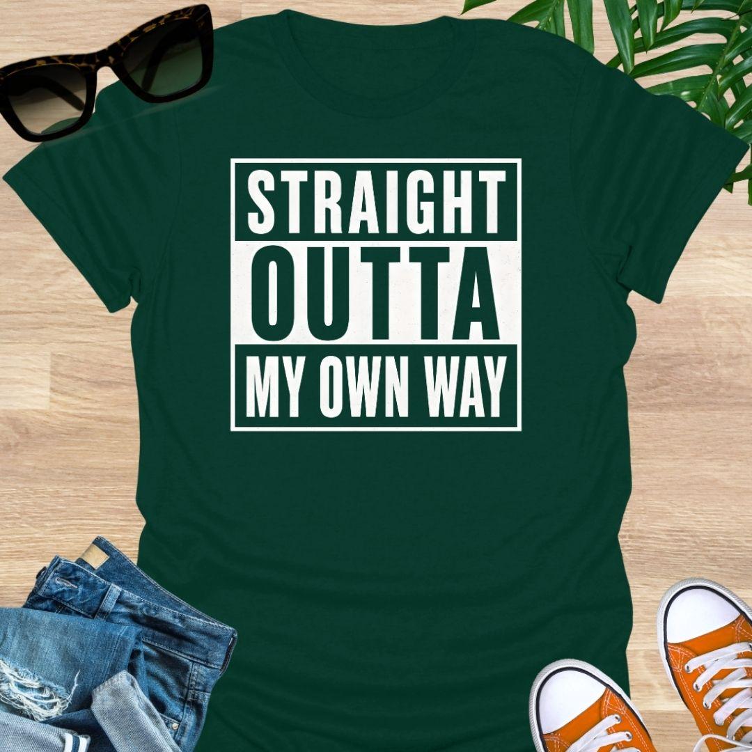 White block text reading “Straight Outta My Own Way” on a forest green unisex tee