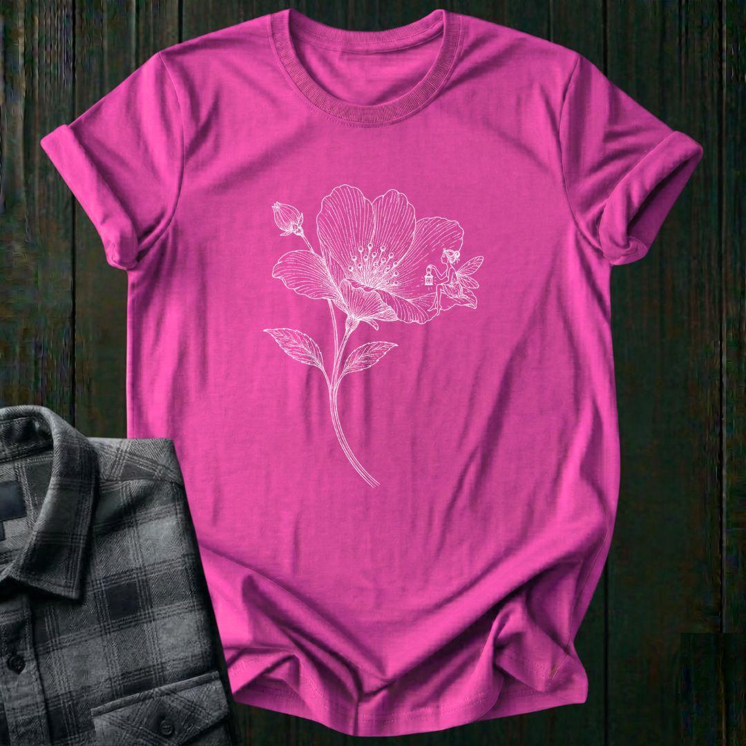 Vintage botanical illustration of a blooming wildflower with a tiny fairy sitting on one petal, surrounded by delicate engraved details and a flower bud on a hot pink tee.