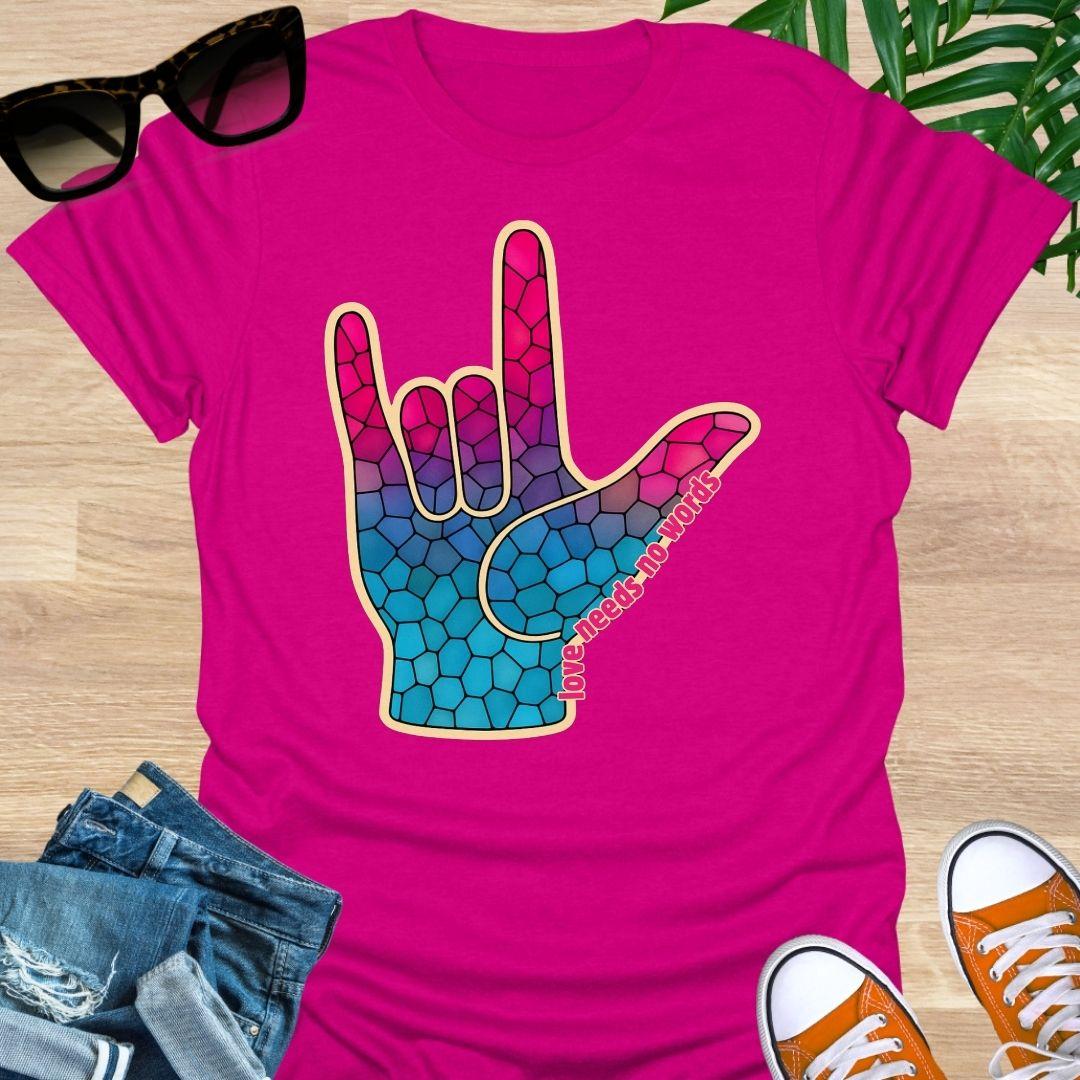 ASL I Love You hand in pink-to-blue mosaic with the words “love needs no words” on a hot pink unisex tee.