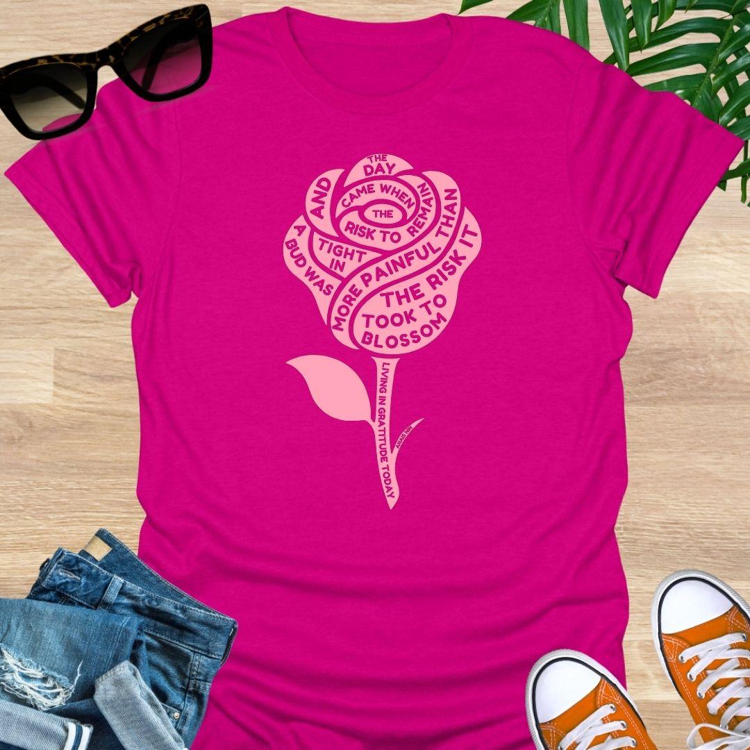 Pink rose with Anaïs Nin “Risk to Blossom” quote on empowerment and growth on hot pink unisex tee