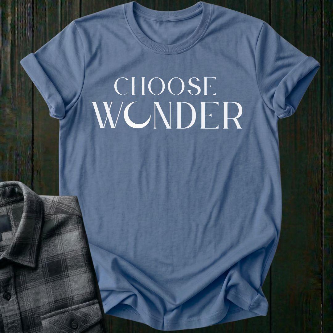 Minimalist typography design featuring the phrase "Choose Wonder" in elegant serif lettering on an indigo blue tee