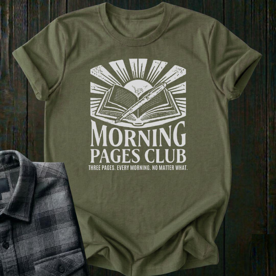 Vintage-style graphic featuring an open journal, pen, and sunrise above the words "Morning Pages Club" with the phrase "Three Pages. Every Morning. No Matter What." on a military green tee. 