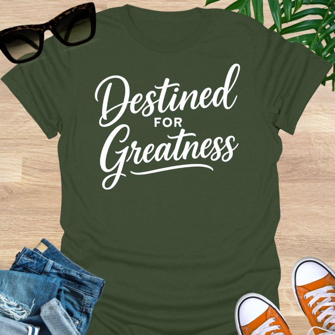 White script text reading “Destined for Greatness” on a military green motivational graphic tee.