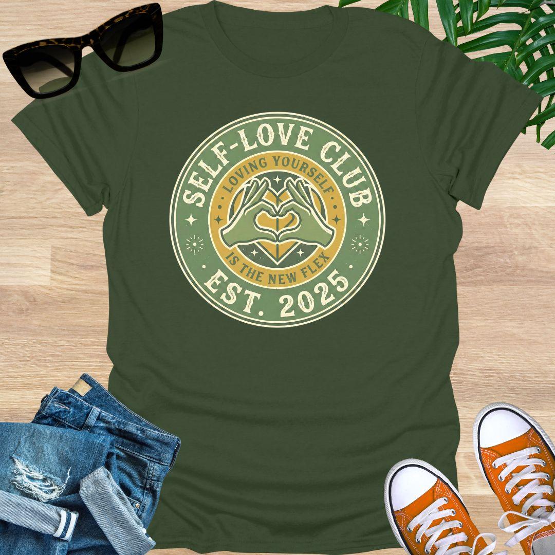 Vintage badge-style design with hands forming a heart and text “Self-Love Club – Loving Yourself Is the New Flex.” on a military green unisex tee