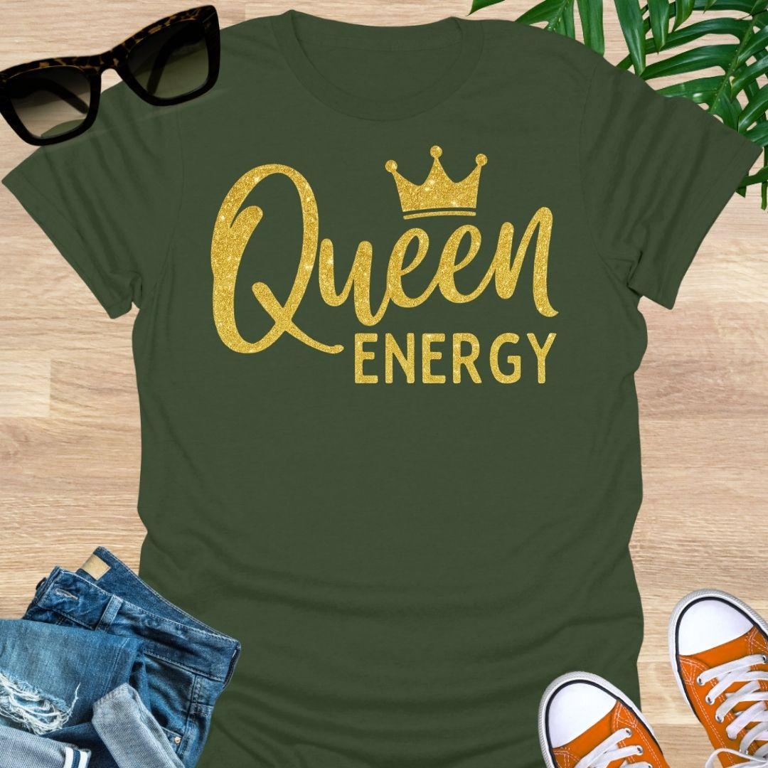 Gold glitter script “Queen Energy” with a crown on a military green empowerment graphic tee.