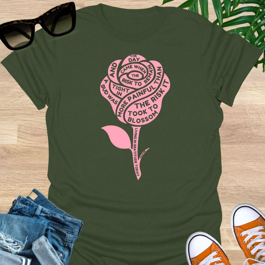 Pink rose with Anaïs Nin “Risk to Blossom” quote on empowerment and growth on a military green unisex tee