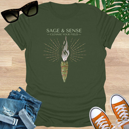 Illustration of a burning sage bundle with radiant lines and the phrase “Sage & Sense Cleanse Your Field” on a military green unisex t-shirt