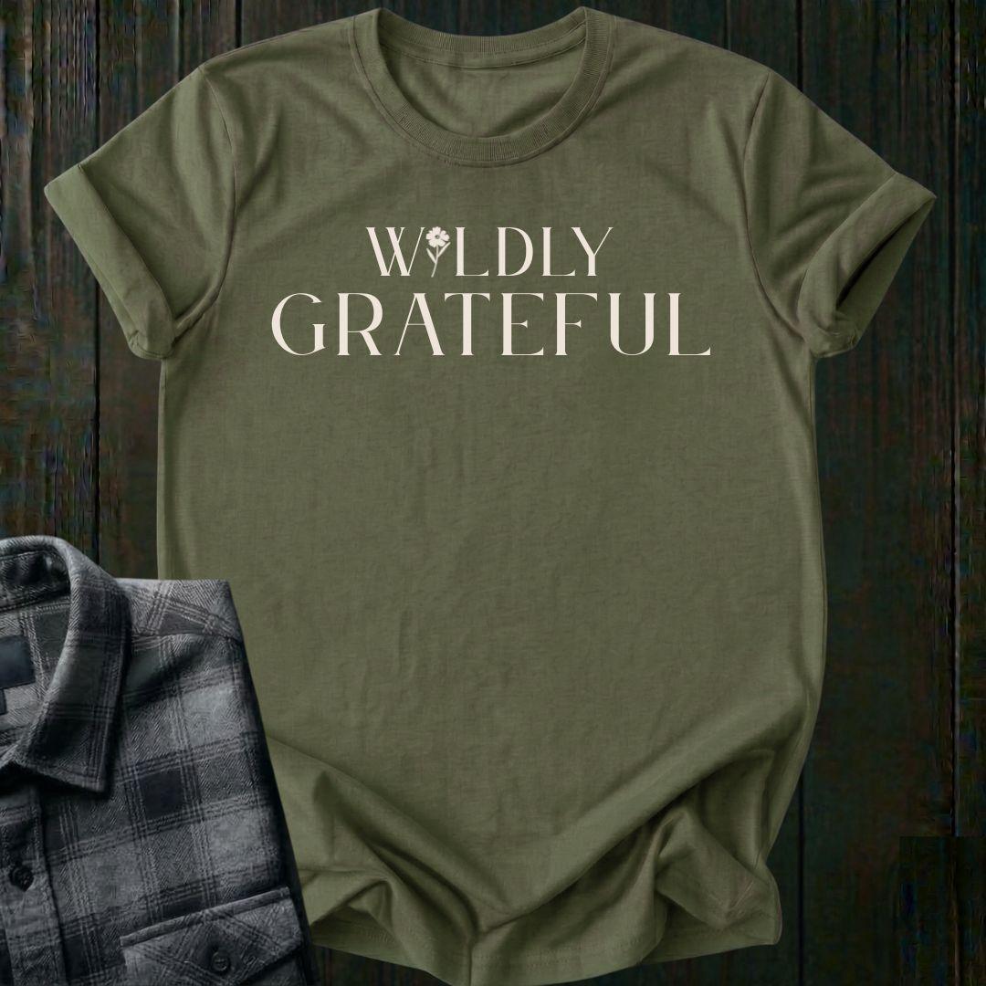 Elegant typography design featuring the phrase "Wildly Grateful" with a flower replacing the letter I in Wildly on a military green tee