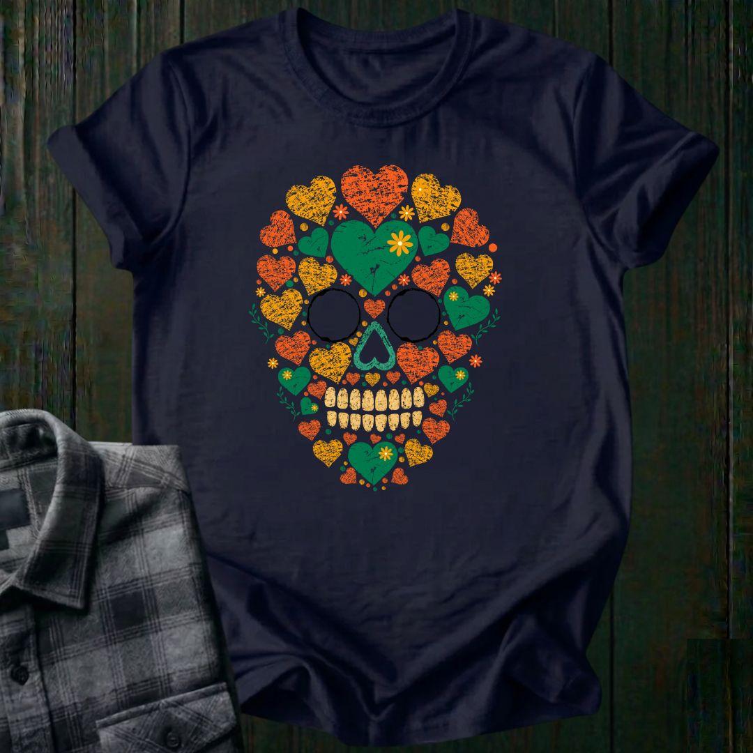 Distressed floral skull graphic made from colorful hearts, flowers, and botanical elements in green, orange, and yellow vintage-style artwork on a navy tee