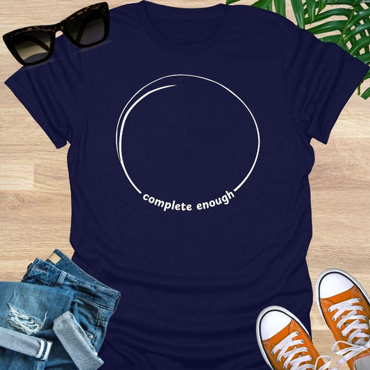 Minimal incomplete circle line art with the words “complete enough” on a navy unisex t-shirt