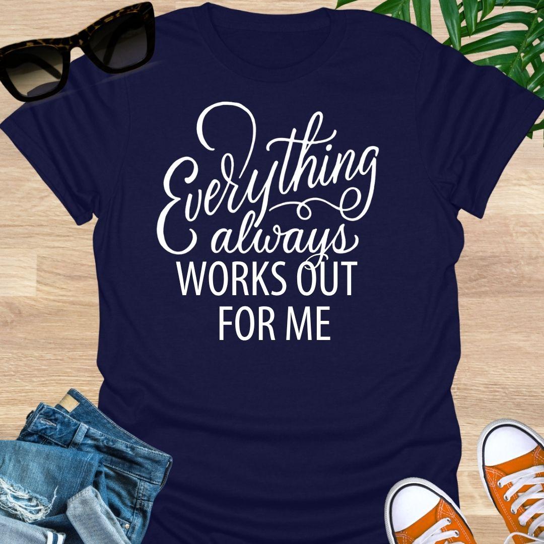 White script text reads “Everything always works out for me” on a navy unisex affirmation tee.